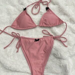 Pink bikini with black bows